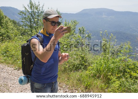 Hiker taking a selfie while out trekking in the mountain. Active hiker. Traveler travel on the artificial roadway of the mountains reserve