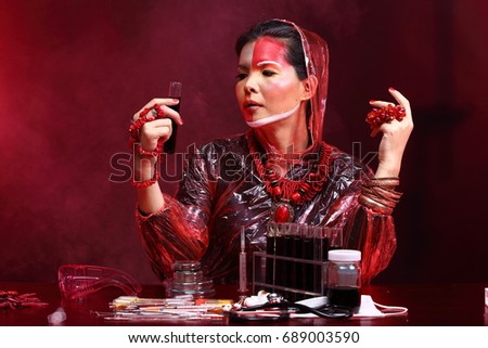 Chemistry Asian Doctor Woman with Red Tone Fashion Make up fancy lab test dress, studio lighting black dark background, safety gear hygiene hat and tube glass