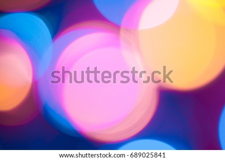 Abstract defocused of blue and yellow LED light on black background. Bokeh photo of LED light. Blue and yellow bokeh. Orange and teal Bokeh. Turquosie background. Azure Background. Amber Background