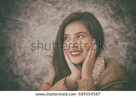 beautiful young woman wearing warm fashionable winter clothes to keep her from the cold