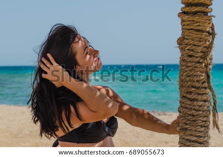 Beautiful girl on the beach in sunny warm day