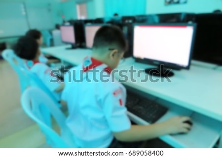 Blur kids and teacher in the  computerroom for background usage.