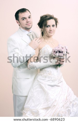 young couple in wedding wear with bouquet of chrysanthemum. Special pink toned photo f/x