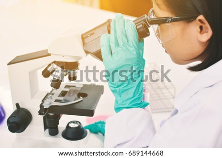 scientist student using microscope experiment  in the laboratory