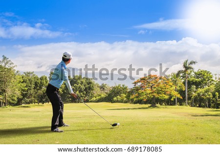 Asian golfer hit a golf ball by golf-club ( tee off  ball by driver (1-wood).