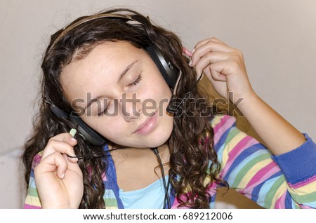 Pretty girl listening music with her headphones and eyes closed