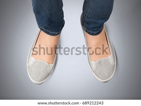 Digital composite of Woman's feet on grey background