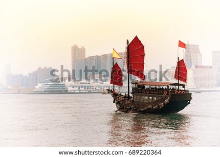 Traditional wooden sailboat sails on in Victoria harbor,Hong Kong.