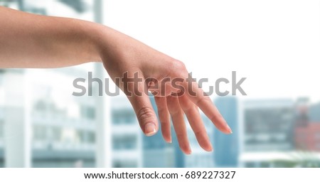 Digital composite of Expressive Hand posing with city background blur