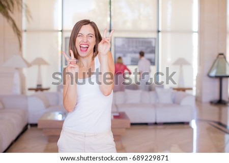 young woman victory sign in a resort