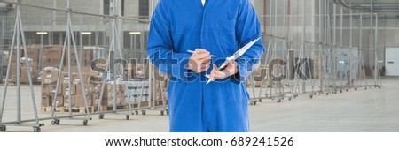 Digital composite of Mechanic man holding a pen and a folder