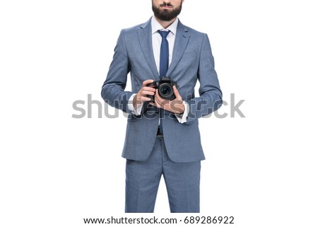 cropped view of male photographer holding professional camera, isolated on white 