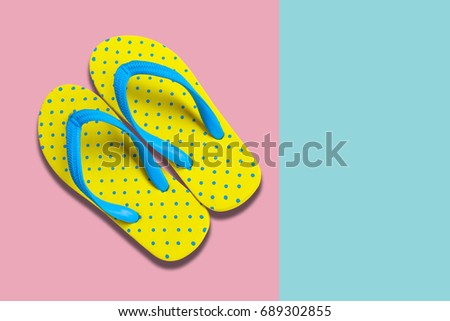 Yellow sandals on pastel color background, flat lay photo