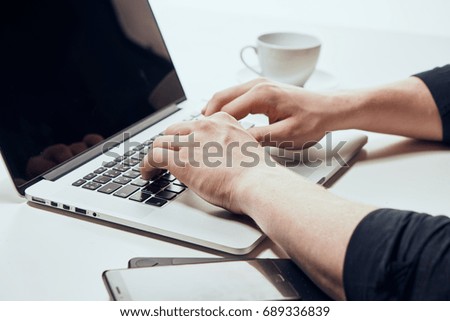 Business man is typing on a laptop keyboard                               