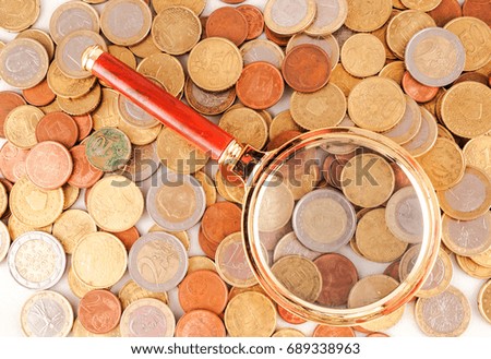 Picture of a Business Money Concept Idea Coins and Loupe Magnify Glass