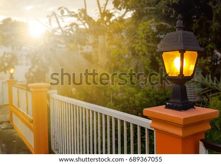 Lamppost in the evening at front home and sunlight.