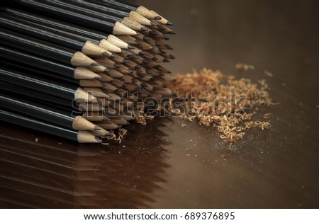 Selective Focus. Pencil group with sharpening machine shadow on the table. 
