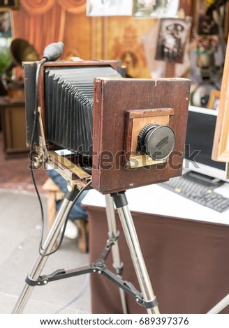 An old retro vintage film camera on a tripod. Large format camera