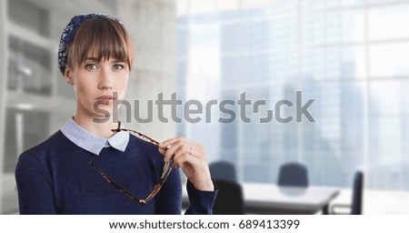 Digital composite of Business woman holding her glasses against office background