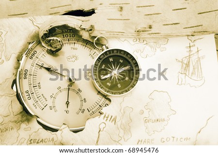 Compass, barometer and old navigating chart of North Europe