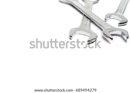 The three open - ended wrenches spanner isolated in the upper right corner of the image with white background and have copy space.