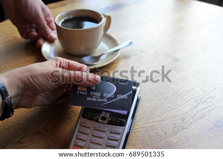 tap pay credit card coronavirus covid 19 ban concept -contactless payment card pdq background copy space with hand holding credit card to pay at cafe restaurant coffee shop smartcard stock photograph