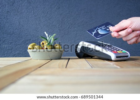 contactless payment card pdq background copy space with hand holding credit card ready to pay at cafe stock, photo, photograph, picture, image