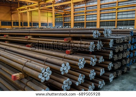 Rows of Steel Round Bar storage and stacking in the warehouse for industrial construction. Royalty-Free Stock Photo #689505928