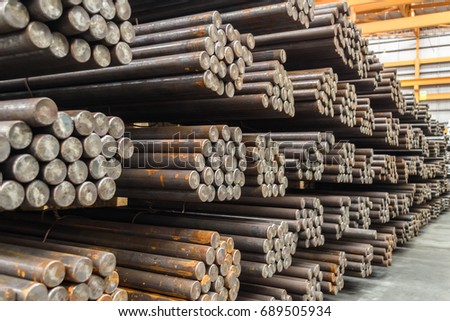 Rows of Steel Round Bar storage and stacking in the warehouse for industrial construction. Shallow focus. Royalty-Free Stock Photo #689505934