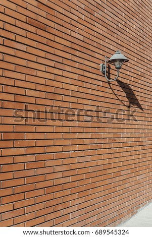 Brown brick wall background with lamp
