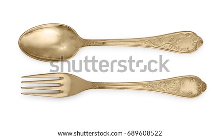 Golden spoon and fork isolated on a white background. Royalty-Free Stock Photo #689608522