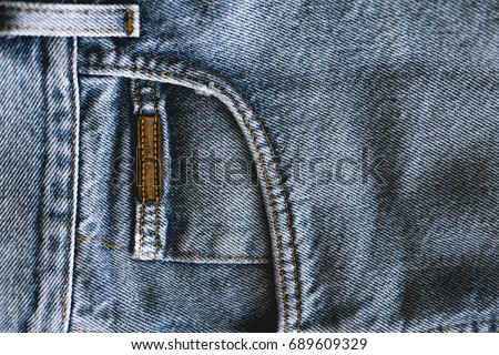 Blue jeans texture on black background. Vintage Denim. Grunge wallpaper