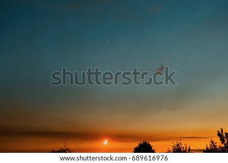 Sunset. The moon in the starry sky. Beautiful gradient.