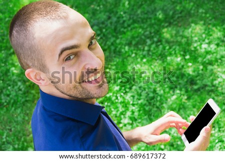 man, using a smart phone, in the hands, background, with copy space