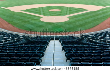Baseball stadium with seating and a baseball diamond with green grass Royalty-Free Stock Photo #6896185