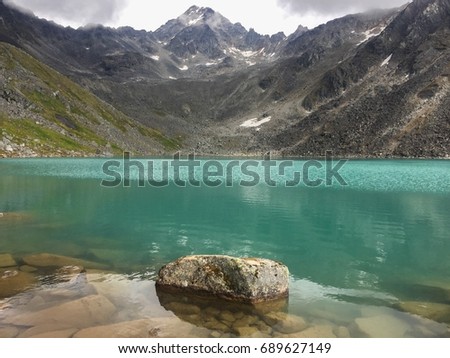 A cool clear mountain lake is soothing to the senses. Royalty-Free Stock Photo #689627149