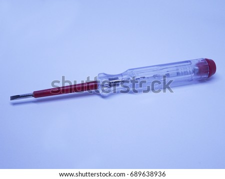 Selective focus of electric test pen screwdriver and voltage detector probe isolated on white background. 