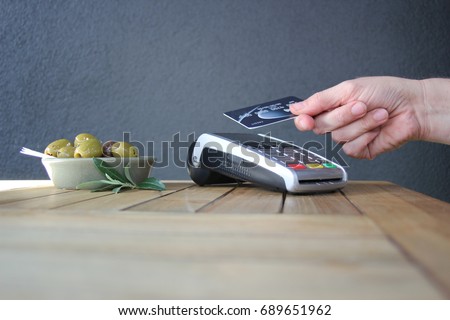 tap pay credit card coronavirus covid 19 ban concept -contactless payment card pdq background copy space with hand holding credit card ready to pay at cafe coffee shop smartcard stock photo photograph