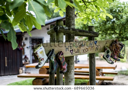 Party Label rubber boots sign wooden, forest tree house Herzlich Willkommen Means Welcome