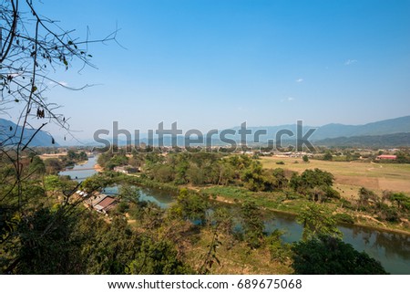 Wide angle picture of amazing view of Nam Song River from Tham Chang Cave in the city of Vang Vieng, Laos. Tropical Vegetation.