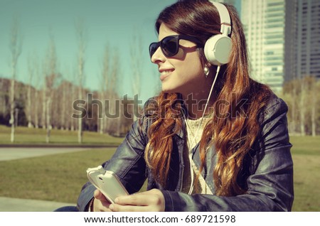 Girl in the park listening music