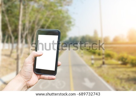 Hand Holding phone with bike lane background 