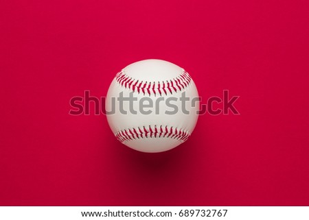 top view of baseball ball on red background