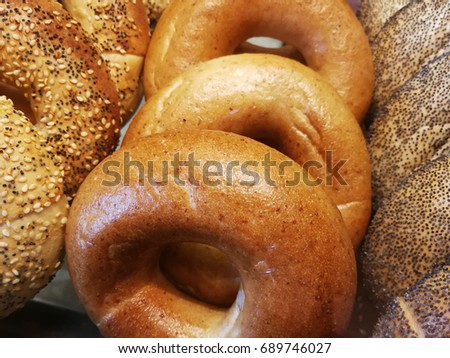 Variety bagels such as multigrain bagel, whole wheat bagel and poppy seed bagel picture to decorate the wall or the background of a bakery shop. The bagel for breakfast, lunch meeting, coffee break.