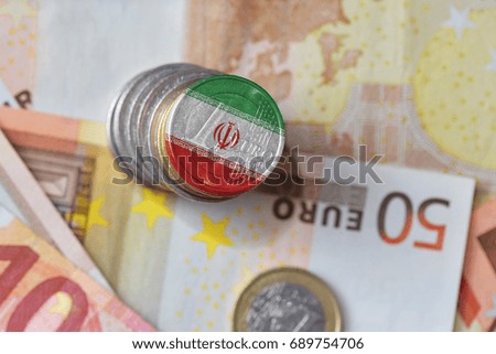 euro coin with national flag of iran on the euro money banknotes background. finance concept