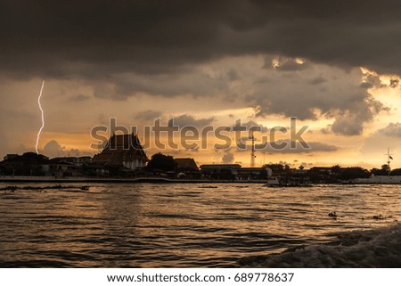 Bangkok summer lightning on the river at sunset