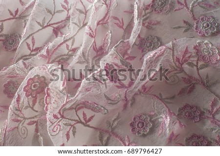  Pink lace decorated with flowers on a white background. Background of pink lace fabric beautifully decorated with flowers