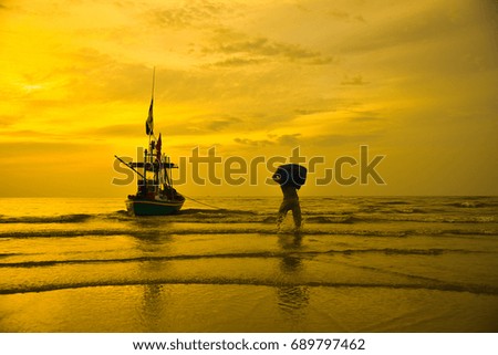 Beautiful early morning sunrise, fishing boat on the seaside, Fishermen prepare to make a living.