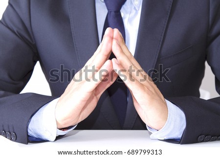 Businessman with hands resting on table