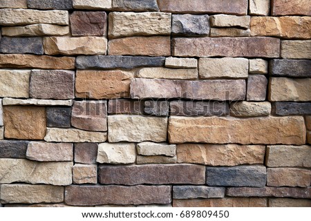 The stone wall texture background natural color.Background of stone wall texture photo.Natural stone wall texture for background.Old Brick texture, Grunge brick wall background. Royalty-Free Stock Photo #689809450